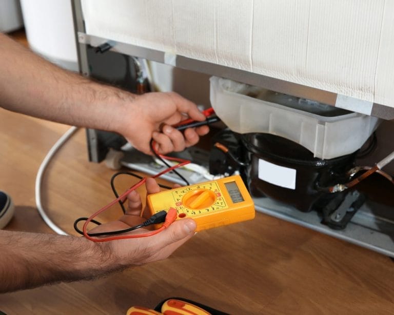 Appliance checkup service in Valrico, FL – handyman inspecting kitchen appliances